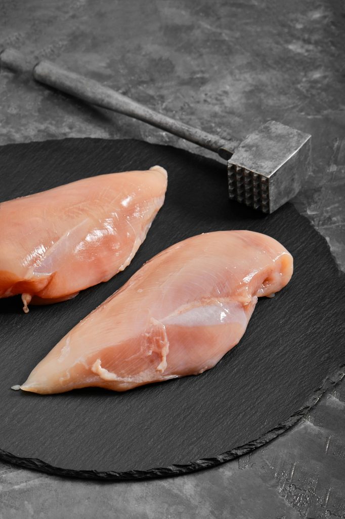 Chicken breasts, raw chicken fillet Photo for a store with natural products. Food delivery, gray