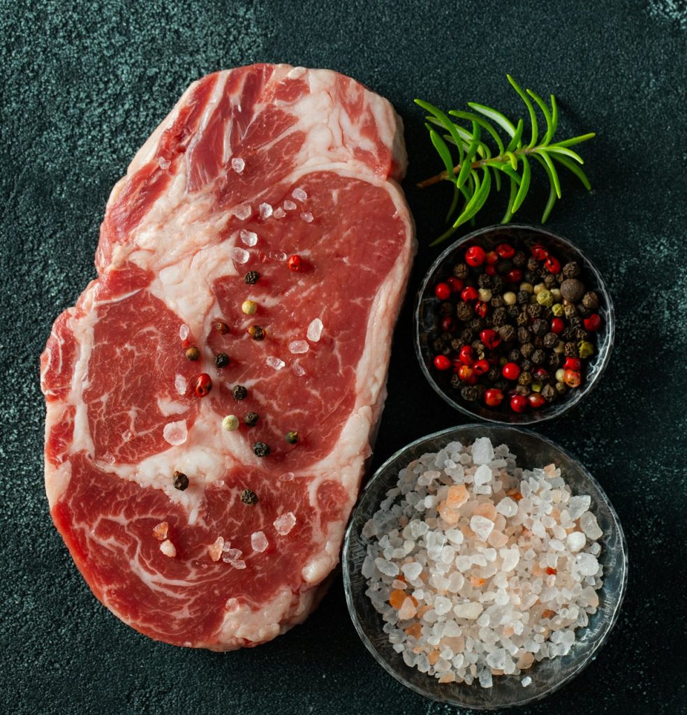 Raw fresh meat Ribeye Steak and seasoning.